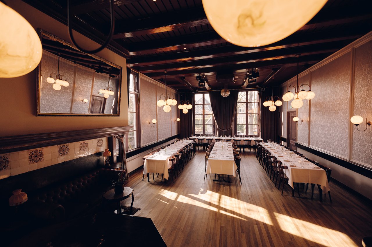 Grote Zaal met vier feestelijk gedekte tafels voor trouwdiner bij Het Broeker Huis